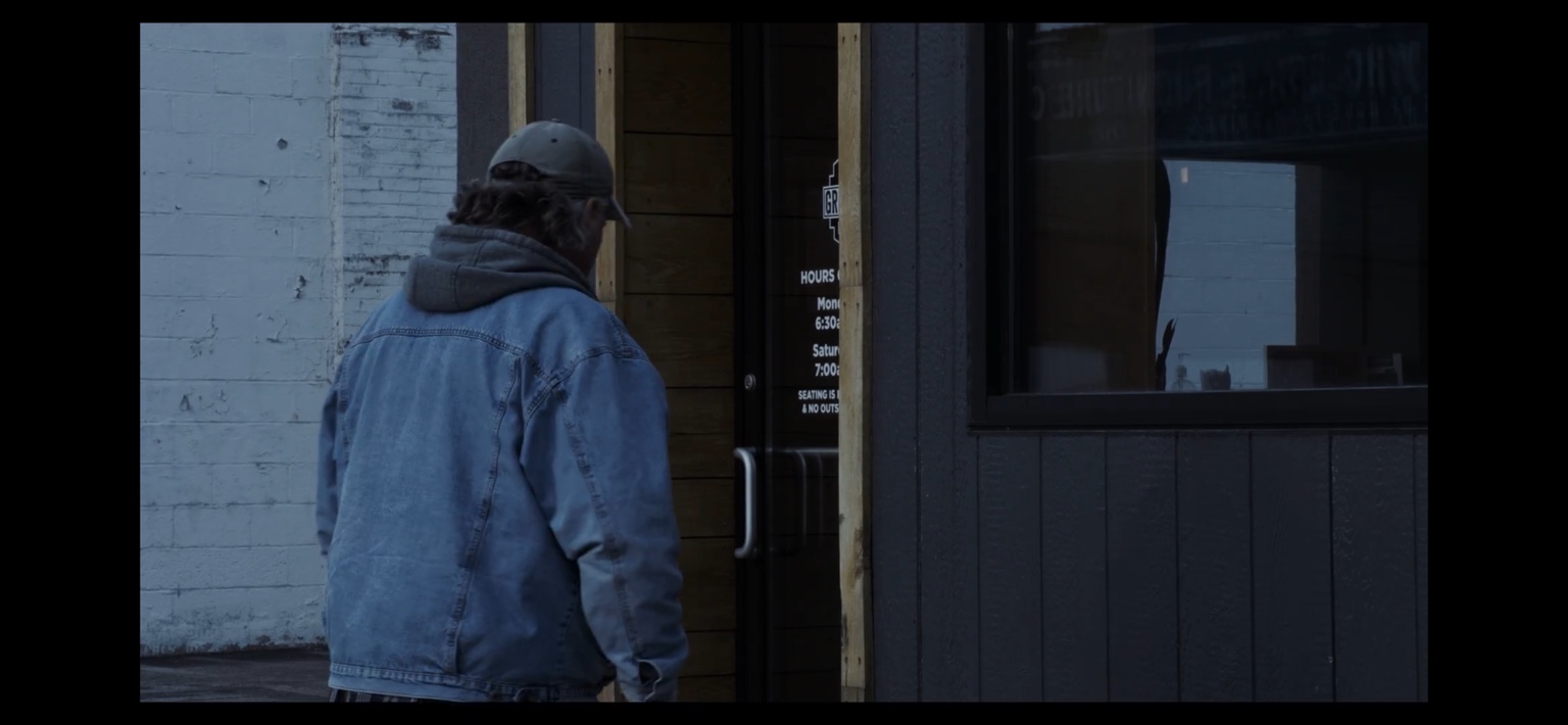 A man arrives at the coffee shop door in The Coffee Shop.