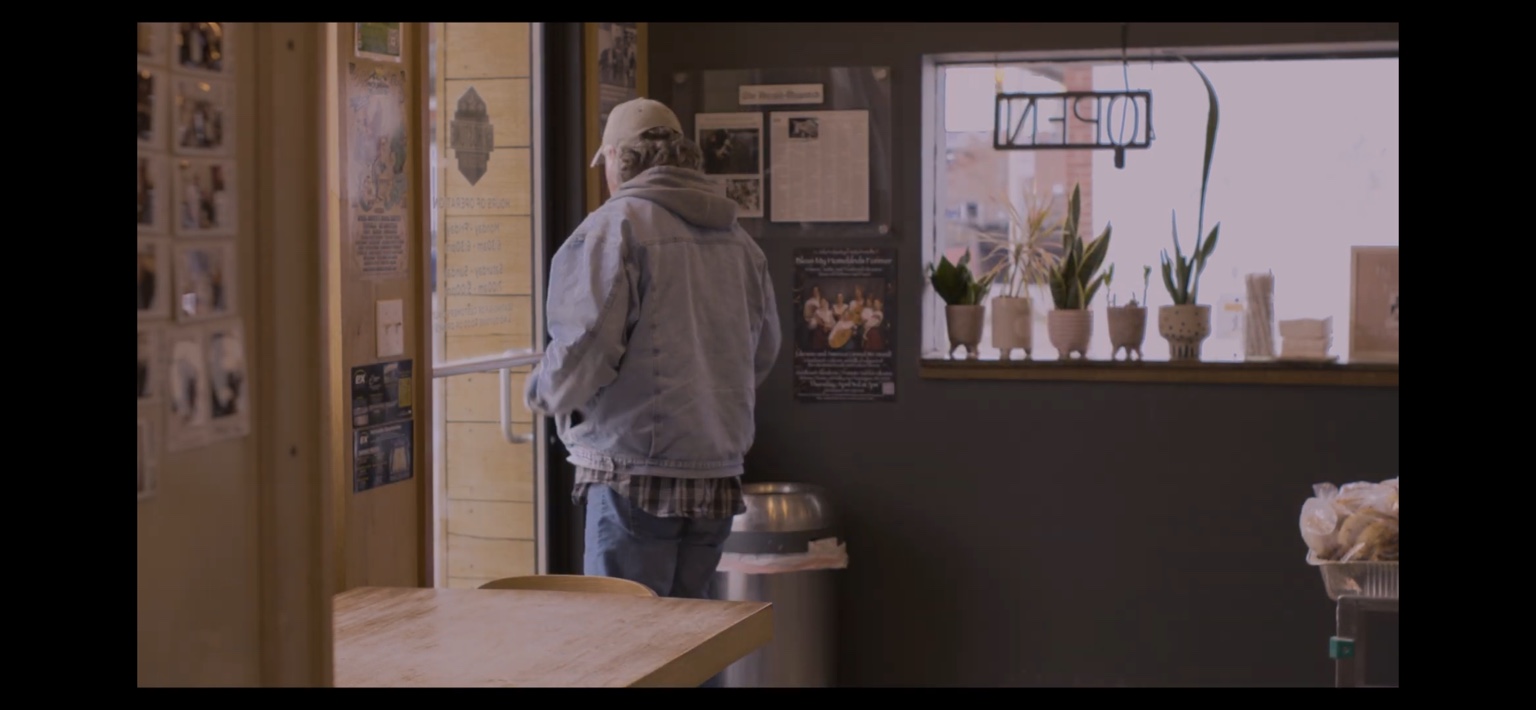 A man enters the coffee shop in The Coffee Shop.