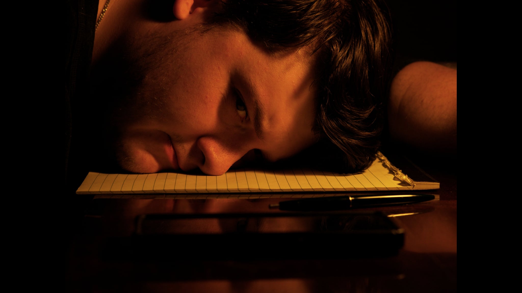 A writer rests beside a notebook in Echoes of a Blank Page.